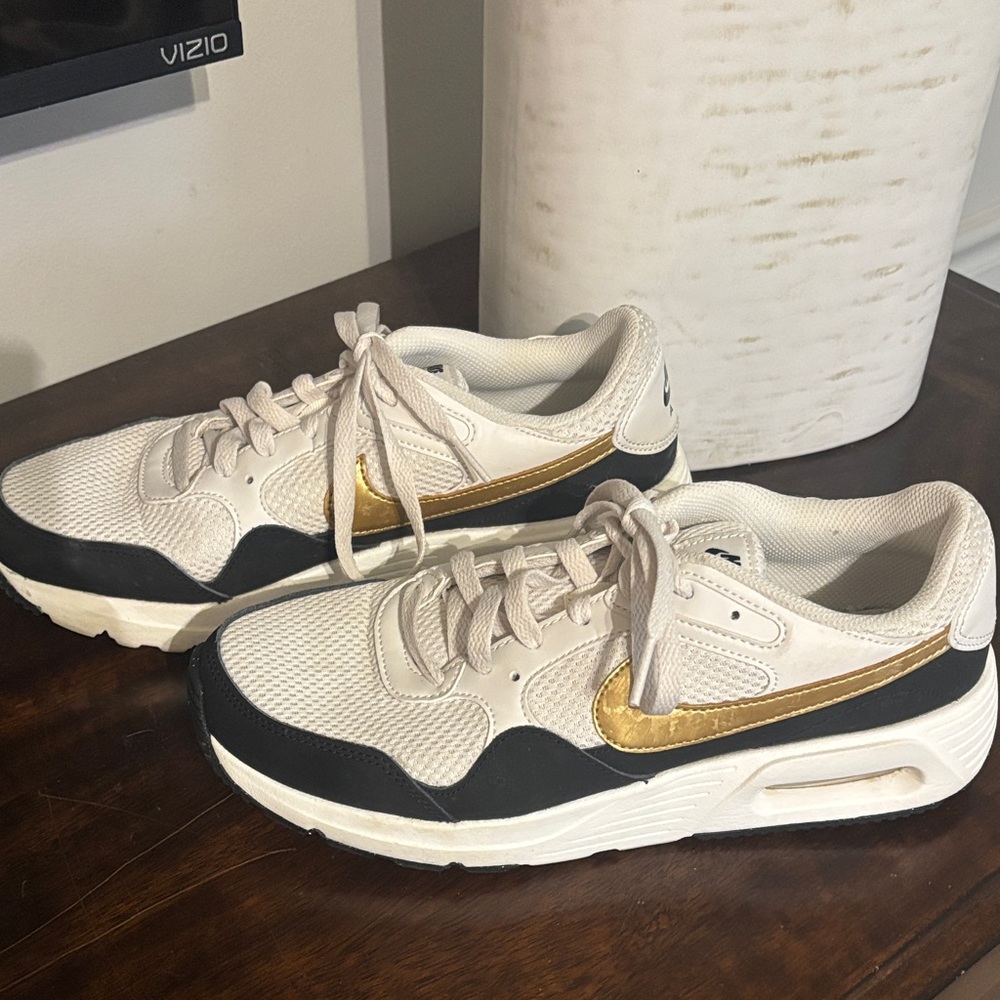 Women’s Nike Air, white, black and gold. Like new, only worn a handful of times